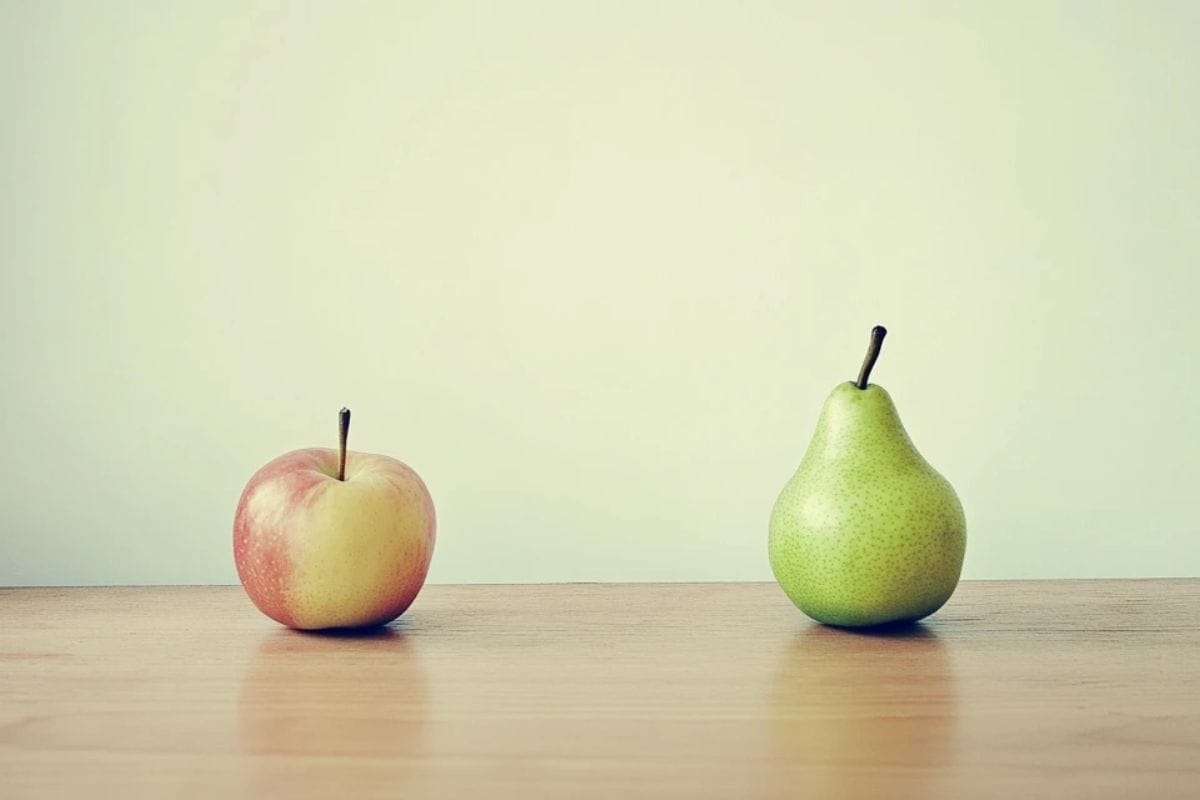 A close-up of fresh apples and pears on a rustic table