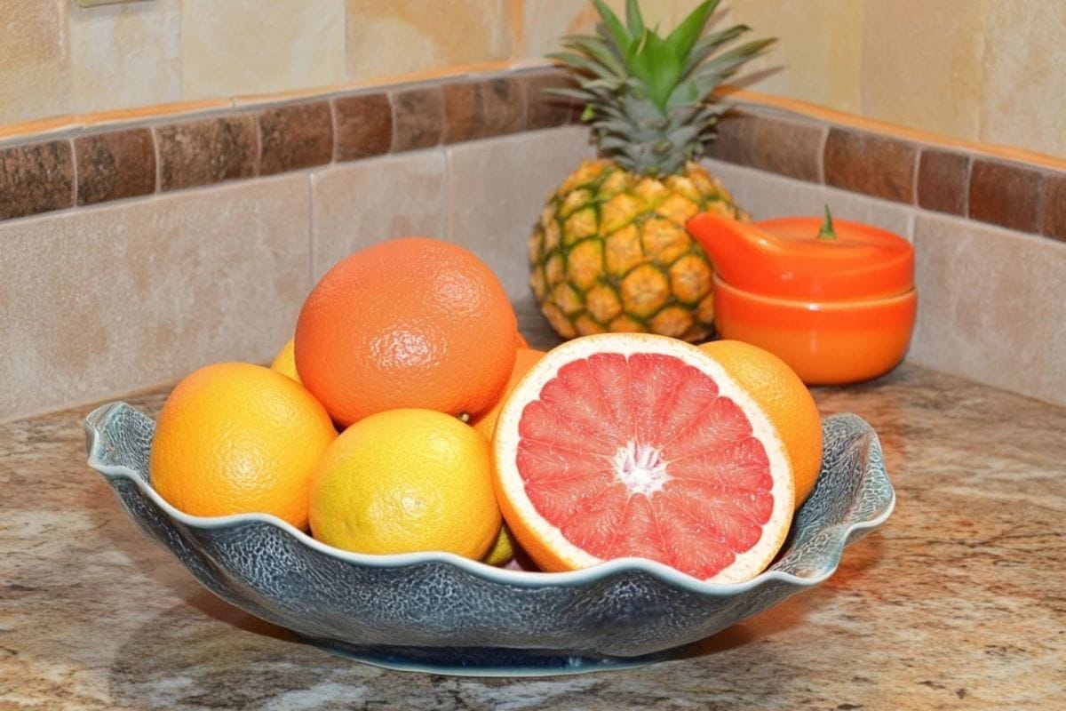 photo of fresh grapefruits and oranges in a fruit bowl