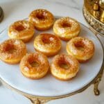 Crème Brûlée Donuts with caramelized sugar topping on a marble plate.