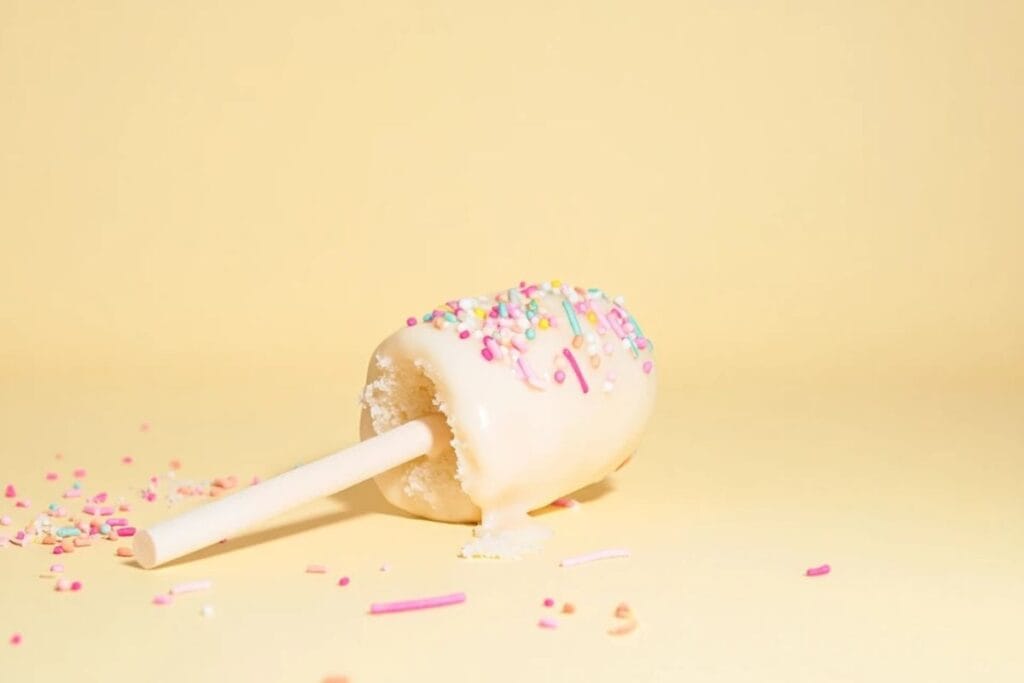 Vanilla birthday cake pop with pink and white sprinkles.