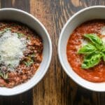 A close-up of ragù and tomato sauce in ceramic bowls.