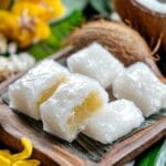 Close-up of traditional Vietnamese coconut candy with fresh coconuts in the background